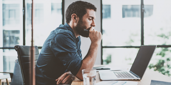 man working on computer serious