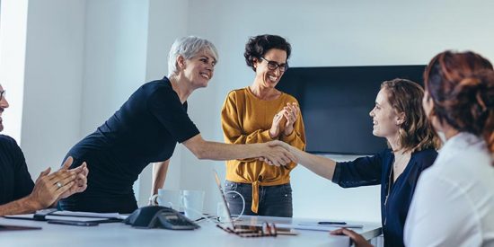 company leaders congratulating new manager on promotion