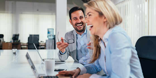 two people in a business meeting happy