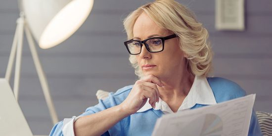 professional woman reading articles on computer