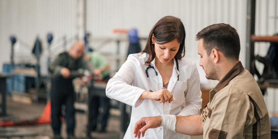 a healthcare professional assisting a workplace injury