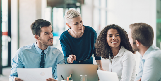 4 people sitting at a table talking about work