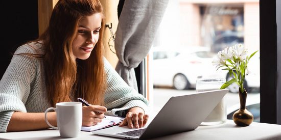 women taking notes while watching webinar