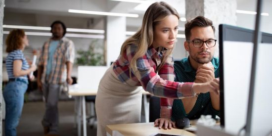 Woman cross-training man on a computer