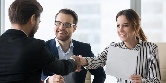 human resources business partner shaking hands with coworker