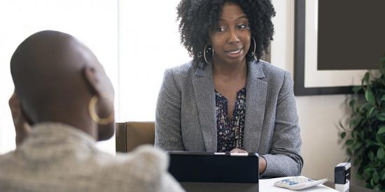 A woman and her employee having a conversation regarding the employee's performance.