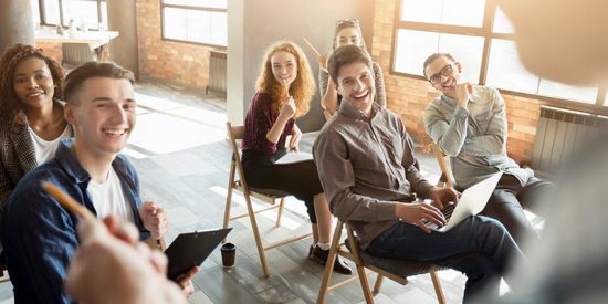 A group of happily, engaged employees participating in training.