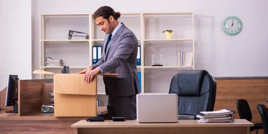 Man packs up his desk after turning in his resignation letter.