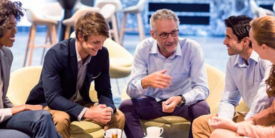 employees talking over coffee in a circle