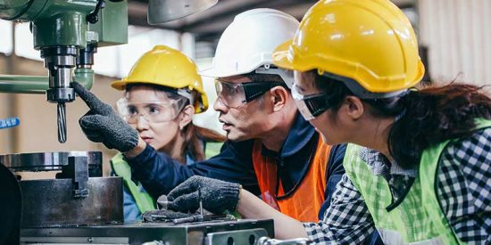 Manufacturers with hardhats on working in a plant